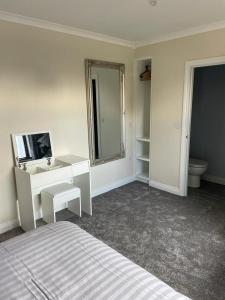 a bedroom with a bed and a sink and a mirror at Mourne View in Killough