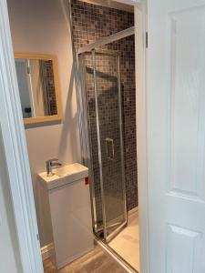 a bathroom with a shower and a sink at Mourne View in Killough