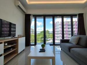 a living room with a couch and a large window at ONE Homestay B 6Pax 2Rooms in Sibu