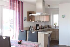 a kitchen with a table with chairs and a counter top at Ferienhaus Brigitte in Carolinensiel