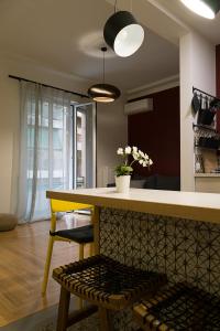 a kitchen with a yellow table and a yellow bench at Athens Special in Athens