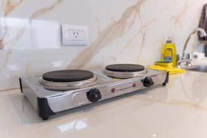 a stove top oven sitting on top of a kitchen counter at Augusta Deluxe in Salta +108 photos