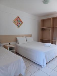 Giường trong phòng chung tại Pousada Paraíso Francês