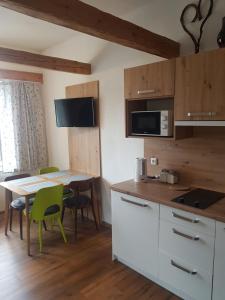 a kitchen and dining room with a table and chairs at Apartmán Červenka in Hartmanice