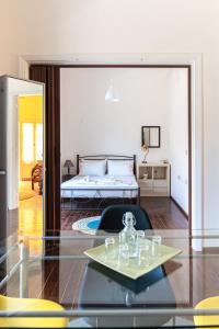 a room with a bed and a glass table at Traditional 2-storey Μaisonette with Terrace in Heraklio