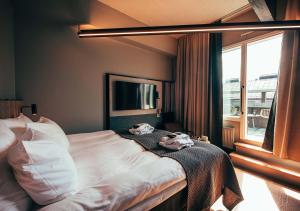 a bedroom with a bed with two towels on it at Clarion Hotel Mestari in Helsinki