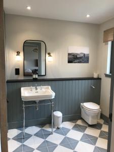 Uig Sands Rooms في Uig: حمام مع حوض ومرحاض