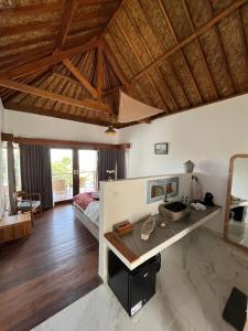 a bedroom with a bed and a desk in a room at The Endless Summer Resort in Bumbang