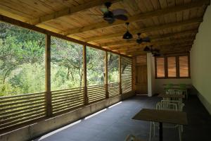 a room with large windows with tables and chairs at Mandrati Loft in Sarpi