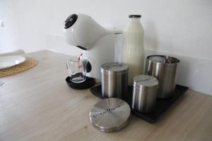 a counter with a blender and a bottle of milk at Family apartment on Repečnik farm in Gorje, Bled in Zgornje Gorje