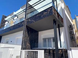 a modern house with a glass facade at IL VIAGGIATORE RELAIS SUL MARE in Gaeta