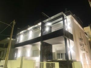 a building with lights on the side of it at night at IL VIAGGIATORE RELAIS SUL MARE in Gaeta