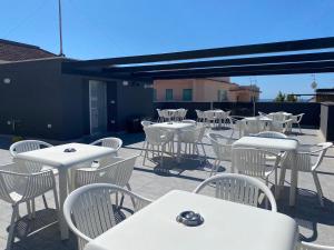 a group of tables and chairs on a patio at IL VIAGGIATORE RELAIS SUL MARE in Gaeta