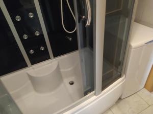una ducha con puerta de cristal en un baño en Sentona Apartment, en Rijeka 33 fotos más