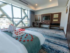 a hotel room with a bed and a large window at White Diamond Hotel Sari in Jeddah