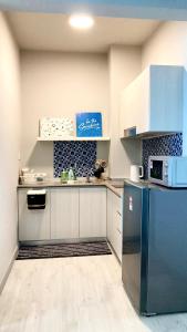La cuisine est équipée d'un réfrigérateur et d'un four micro-ondes. dans l'établissement Mango House2-SeaView,Wifi,Swimmingpool,Gym-JQ, à Kota Kinabalu