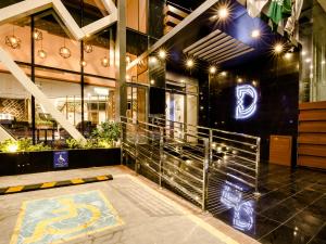 a lobby of a building with lights on the wall at White Diamond Hotel Sari in Jeddah