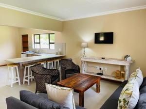 a living room with a couch and a table at Travalia Guest Farm in Nelspoort