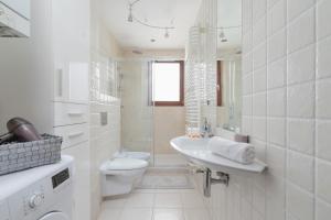 uma casa de banho branca com um WC e um lavatório em Cracow Skałki Twardowskiego Tyniecka by Renters em Cracóvia