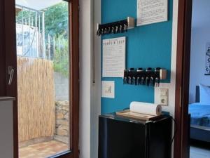 a door to a room with a refrigerator and a window at Ferienwohnung Coco in Schallstadt