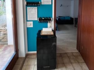 a hallway with a door to a room with wine bottles at Ferienwohnung Coco in Schallstadt