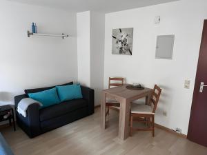 a living room with a couch and a table at Ferienwohnung Coco in Schallstadt