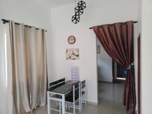 a room with a table and a window with curtains at D'NAS HOMESTAY - Muslm Only in Sungai Besar