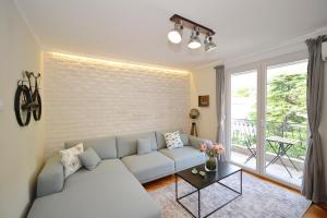a living room with a couch and a brick wall at The Nest - Urban Family place in Kotor