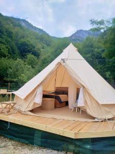 a tent sitting on a wooden deck in the water at Tiny House Village Resort 