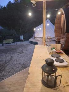 a tent with a stove and a stove top oven at Tiny House Village Resort 