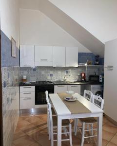 a kitchen with a white table and white cabinets at A 'Du Passi in Castellammare del Golfo