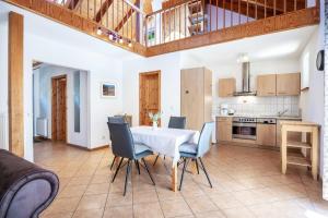 a kitchen and dining room with a white table and chairs at Ostsee Landurlaub auf dem Ferienhof OFC 21 in Kröpelin