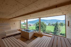 a room with a sauna with a large window at Hotel Bussi Baby in Bad Wiessee