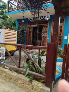 a house with a gate in front of it at Pousada Exuberante in Abraão