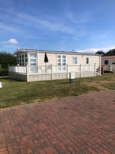 a house with a white fence in front of it at Tide Away Anderby Creek in Anderby +14 photos