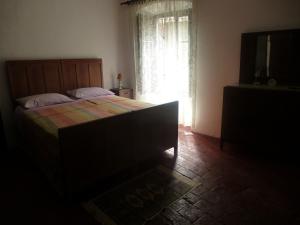 a bedroom with a large bed and a window at Appartamento Piagnaro in Pontremoli