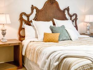 a bedroom with a large bed with pillows at Highland Village, TX. Charming mid-century ranch. in Highland Village