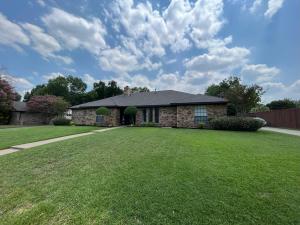 a house with a large lawn in front of it at Highland Village, TX. Charming mid-century ranch. in Highland Village