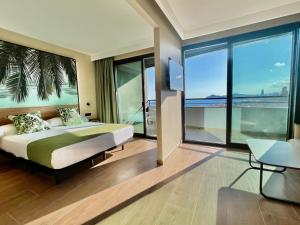 a bedroom with a bed with a view of the ocean at Hotel Primavera Park in Benidorm
