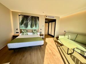 a hotel room with a bed and a couch at Hotel Primavera Park in Benidorm