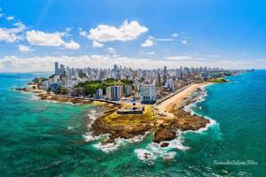 an aerial view of a city and the ocean at Ondina Praia Apartamento in Salvador