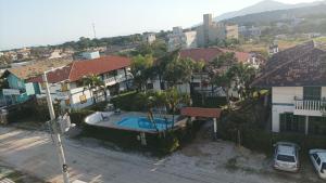 een luchtzicht op een stad met huizen en een zwembad bij CONDOMINIO COLONIAL APARTAMENTOS 150M DA PRAIA in Bombinhas