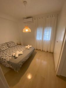 a bedroom with a bed with two towels on it at Arenal Sweet Boutique in Platja de l'Arenal