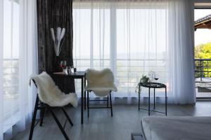 a room with a table and chairs and a window at Horizont Dedine in Golubac