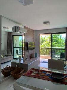 a large living room with a view of a patio at Eco Life Beach Class - Muro Alto Flat beira mar in Porto De Galinhas