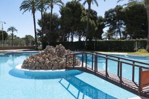 a swimming pool with a pile of rocks in it at Florazar 2, Vi-3-B in Faro de Cullera