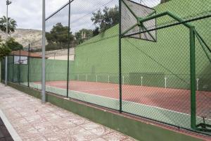 a tennis court with a fence on a tennis court at Florazar 2, Vi-3-B in Faro de Cullera