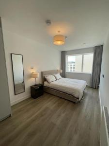 una camera con un letto e una grande finestra di Greystones Marina View Penthouse a Greystones