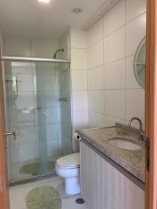 a bathroom with a shower and a toilet and a sink at Eco Life Beach Class - Muro Alto Flat beira mar in Porto De Galinhas