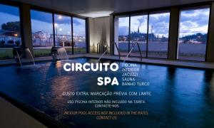 a swimming pool in a building with windows at Hotel Villa Batalha in Batalha +72 photos